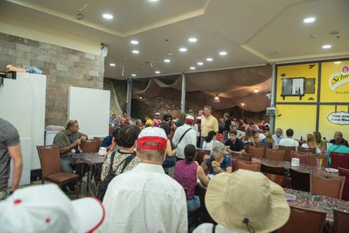 a large group of people sitting in a room at La Casetta in Nazareth