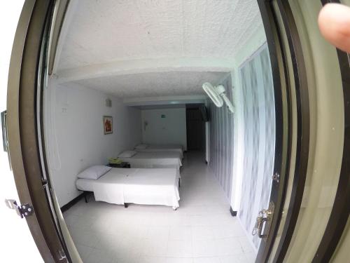 a hallway with three beds in a room at Sky Club Eco Hotel in Belén de Umbría