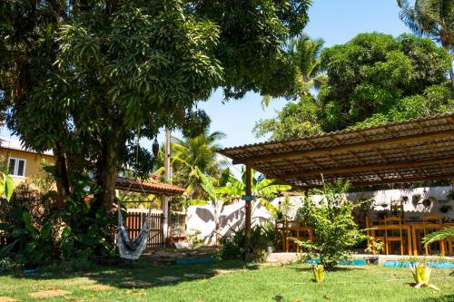 a house with a yard with a pool and trees at Coroaci Beach House in Barra Grande