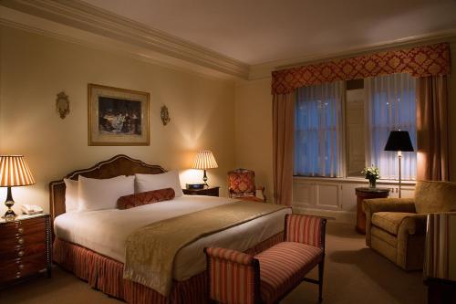 a hotel room with a bed and a chair at The Sherry Netherland in New York