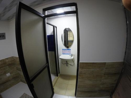 a bathroom with a mirror and a sink at Sky Club Eco Hotel in Belén de Umbría