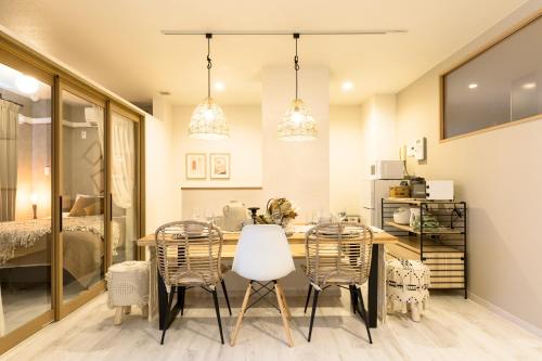 a dining room with a table and chairs at eni minamihorie Kaede in Osaka