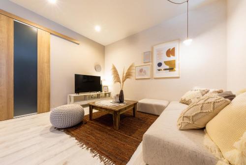 a living room with a couch and a tv at eni minamihorie Kaede in Osaka