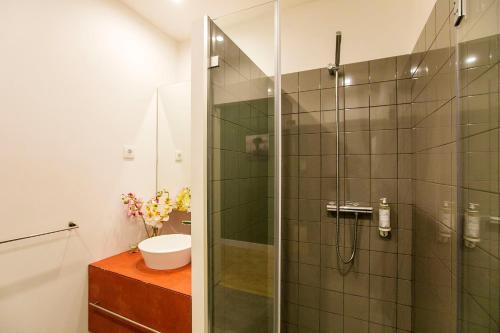 a bathroom with a shower and a toilet and a sink at Casa da Cordoaria in Porto
