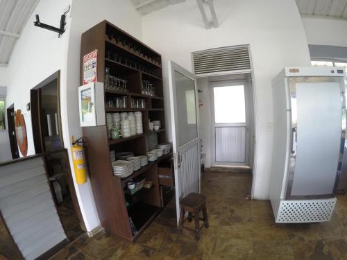 a room with a shelf with dishes in it at Sky Club Eco Hotel in Belén de Umbría