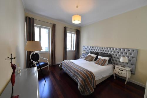 Ένα ή περισσότερα κρεβάτια σε δωμάτιο στο Villa Jasmineiro