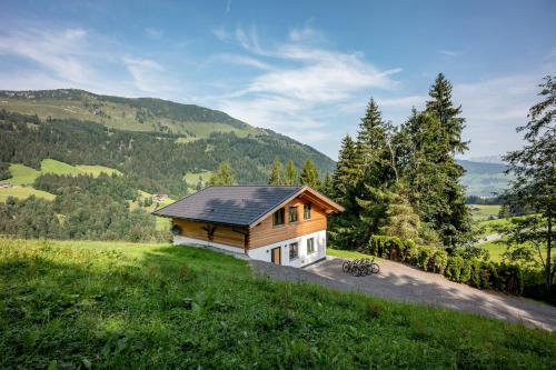 a small house on a hill with a view at Chalet Alpenherz in Kirchberg in Tirol