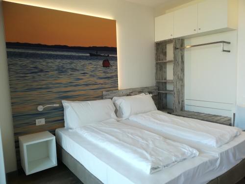 a bedroom with a bed with a view of the water at Locanda San Marco in Torri del Benaco
