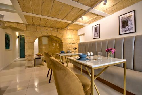 a dining room with a table and chairs at 23 Boutique Hotel in Il-Furjana