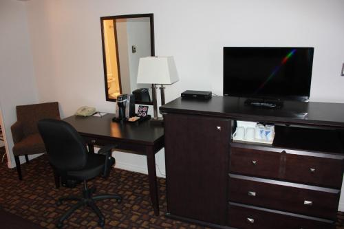 a hotel room with a desk with a television and a deskablish at Coronet Hotel in Prince Albert