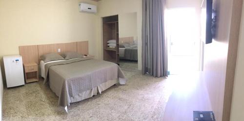 a bedroom with a bed and a mirror at Hotel Rotamerica in Campinorte