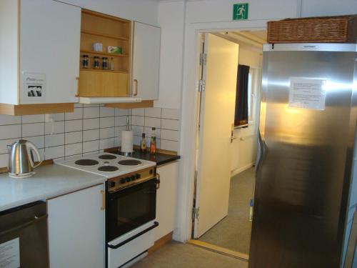 a kitchen with a stainless steel refrigerator and stove at Polar Lodge in Kangerlussuaq