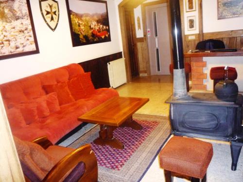 a living room with a couch and a wood stove at Hotel Chbat in Bcharré
