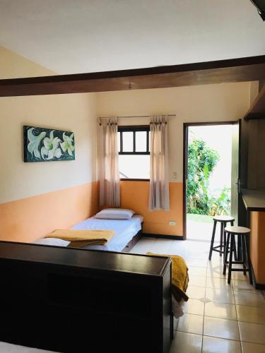a bedroom with two beds and a large window at Residencial Vilamar in Ilhabela