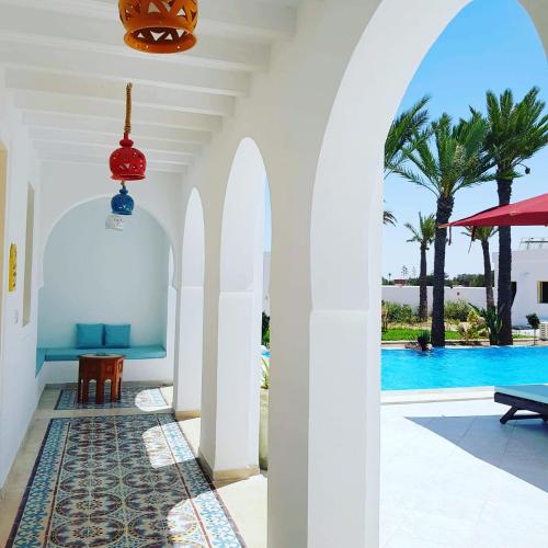 an archway leading to the pool at a villa at Dar El Jerbi in Mezraya
