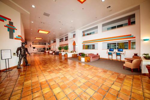 a large lobby with a man standing in the middle of a room at Howard Johnson by Wyndham Gallup in Gallup