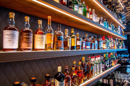 a shelf filled with lots of bottles of alcohol at Meiser Design Hotel in Dinkelsbühl