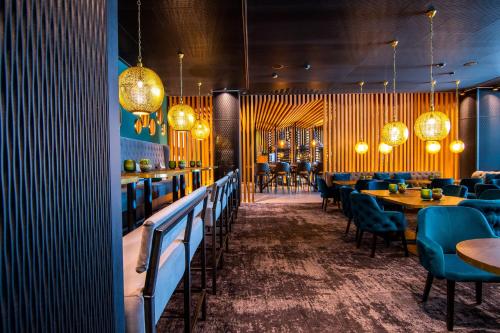 a restaurant with tables and chairs and lights at Meiser Design Hotel in Dinkelsbühl