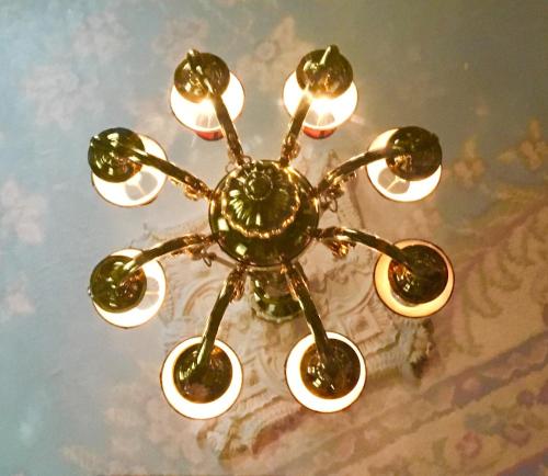 a chandelier with eight lights on a table at Peace & Plenty Inn Bed and Breakfast Downtown St Augustine-Adults Only in Saint Augustine