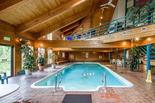 a large indoor swimming pool with a wooden ceiling at Timber Ridge 504B in Silverthorne