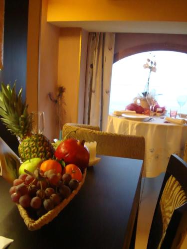 a bowl of fruit on top of a table at B&B Acireale - Il Cavalluccio Marino Fronte Mare in Acireale