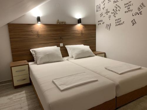 a bedroom with a large bed with two towels on it at Apart 31 in Cetinje