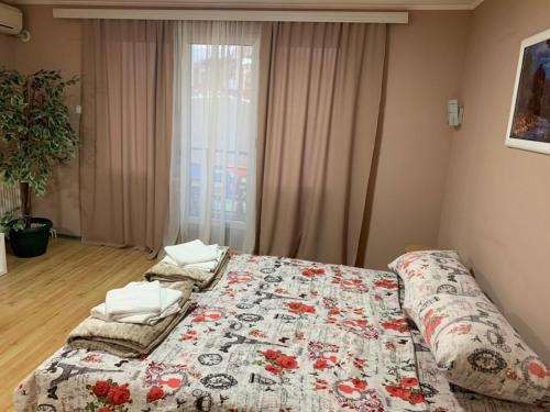 a bedroom with a bed with a quilt on it at La Apartamento Centroom in Jagodina