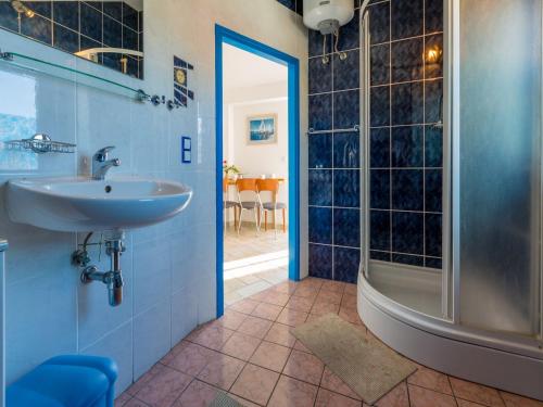 a bathroom with a sink and a shower at Apartments Dubravka in Crikvenica