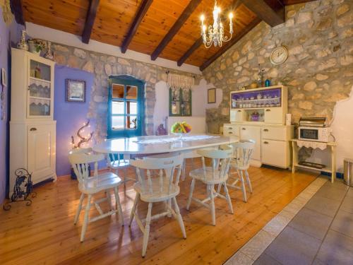 a kitchen with a table and chairs in a room at House Casa Rustica in Grižane