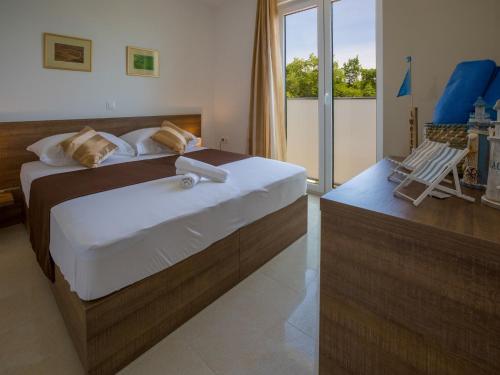 En eller flere senge i et værelse på Apartments Villa Grande