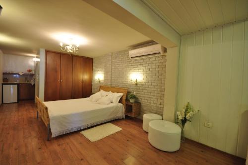 a bedroom with a bed and a table at Sea Of Galilee Site in Chorazim