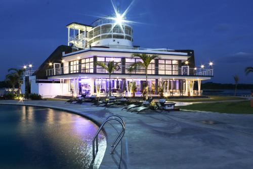 a building with a pool in front of it at night at Doulos Phos The Ship Hotel in Lagoi