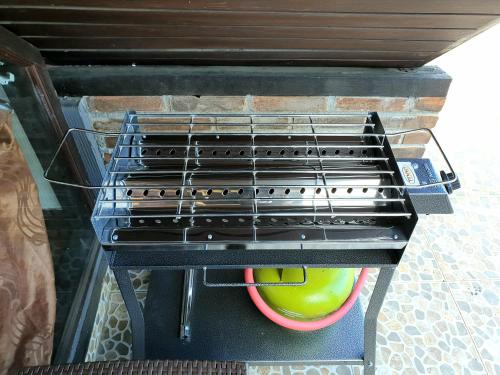 a grill with a yellow ball in a basket at Bedugul Lake View Residence Unit B-6 in Bedugul