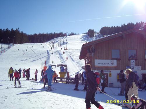 a group of people on a ski slope at a ski lodge at Pension Herzoghäusel in Bischofswiesen
