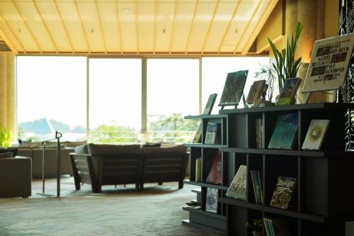 a library with a book shelf filled with books at Matsushima Ichinobo in Matsushima