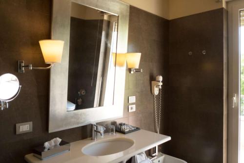 a bathroom with a sink and a mirror at Villa Maria Hotel & SPA in Francavilla al Mare