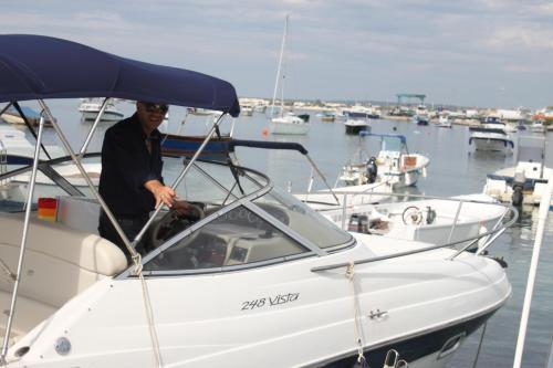 a man is on a boat in a marina at Hotel Royal - Beauty & Spa in Porto Cesareo