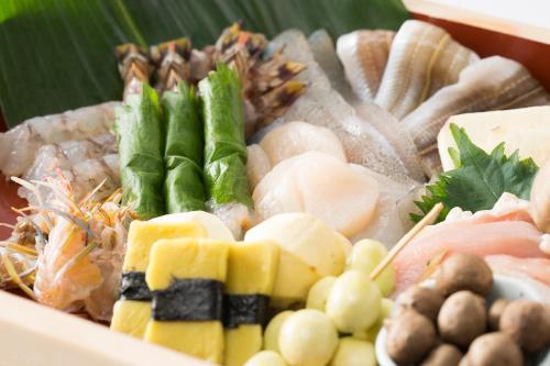 a box filled with different types of seafood and vegetables at Hotel Nikko Kansai Airport - 3 mins walk to the airport in Izumi-Sano