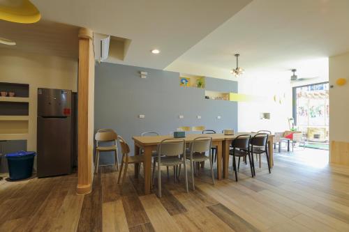 a dining room with a table and chairs at Colorful Balloons Homestay in Magong