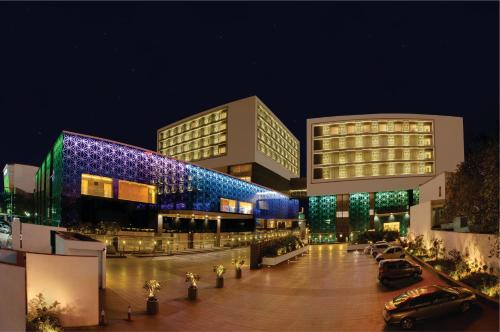 a building with cars parked in front of it at night at Orange Megastructure LLP in Surat