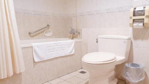 a bathroom with a white toilet and a towel at Green World Flora Annex in Taipei