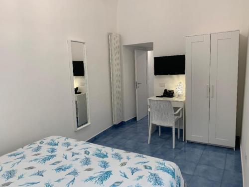 a bedroom with a bed and a table and a desk at Villa Spring Apartments in Meta