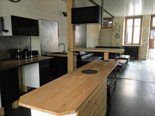 a kitchen with a wooden counter top in a room at La Rénovée d’Antan in Avallon