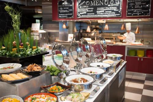 a buffet line with many different dishes of food at Hotel Nikko Kansai Airport - 3 mins walk to the airport in Izumi-Sano