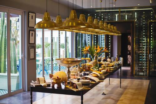 a buffet line with food on a table in a room at Majeka House Boutique Hotel by The Living Journey Collection in Stellenbosch