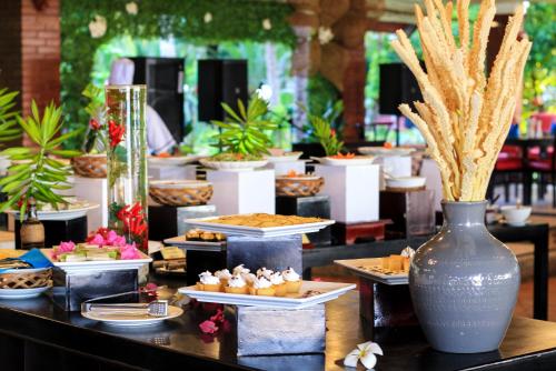 a buffet of food on a table with plates of food at Four Oceans Beach Resort - Bon Bien Mui Ne in Mui Ne