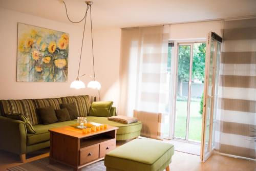 a living room with a couch and a table at Schmitzbergergut in Braunau am Inn