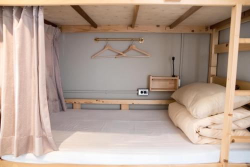 a bedroom with a bunk bed and a desk at 框框背包客棧 Kuang Kuang Hostel in Longjing