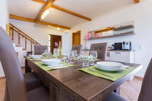 a dining room with a large wooden table with chairs at The Sun Hill in Lagos