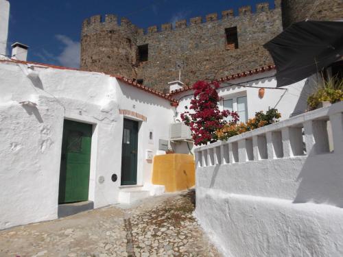 a street in front of a castle with white buildings at Encosta do Castelo in Portel